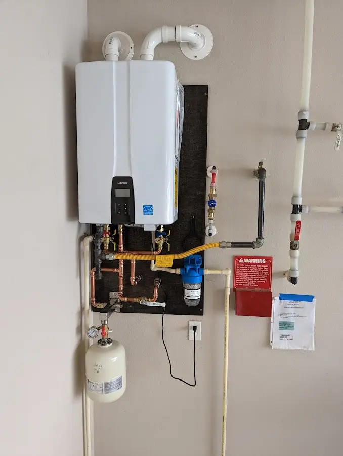 Professional plumber installing copper piping in a Tallmadge home